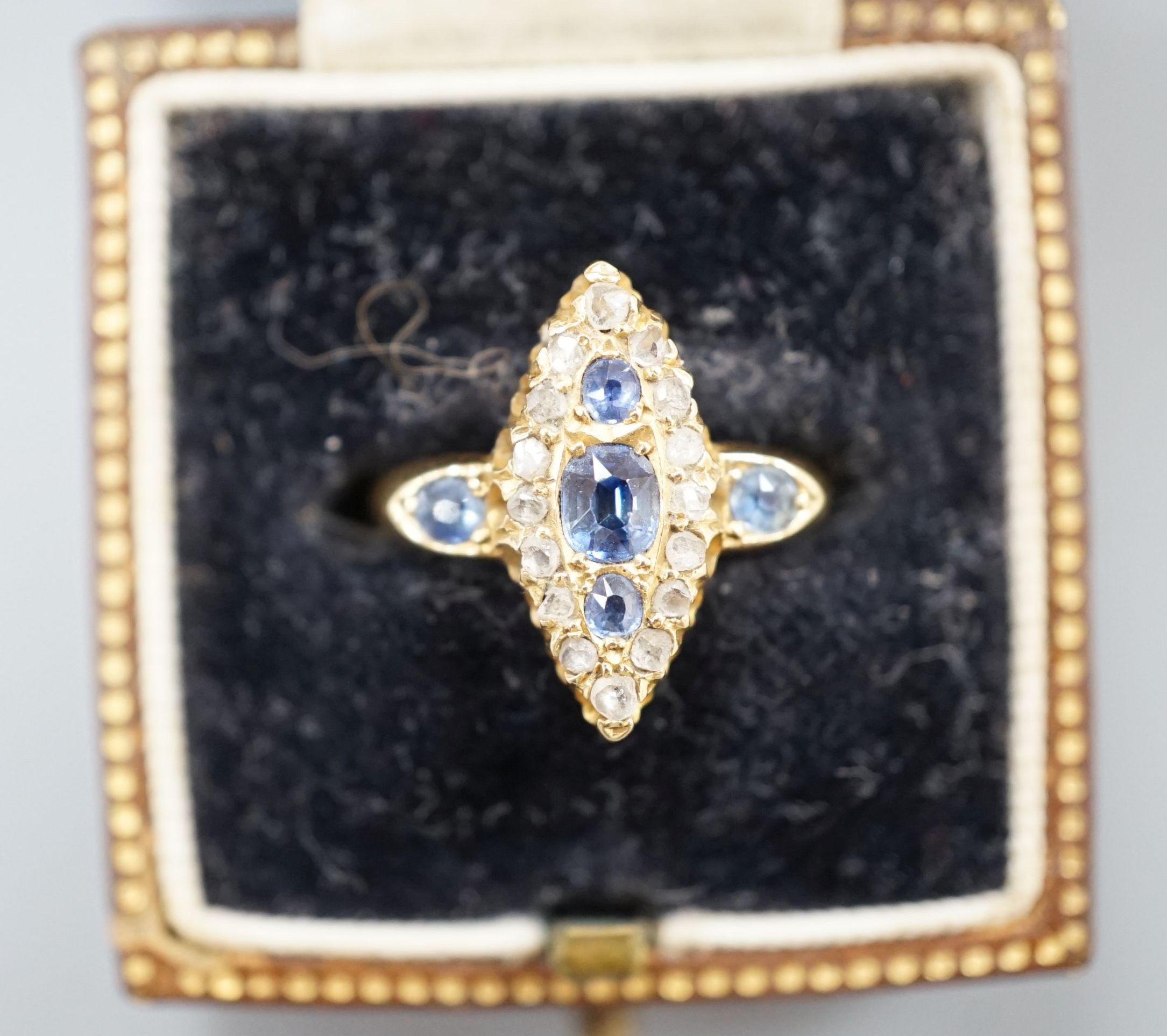 An Edwardian 18ct gold, sapphire and diamond set marquise set cluster ring, size K, gross weight 3.2 grams